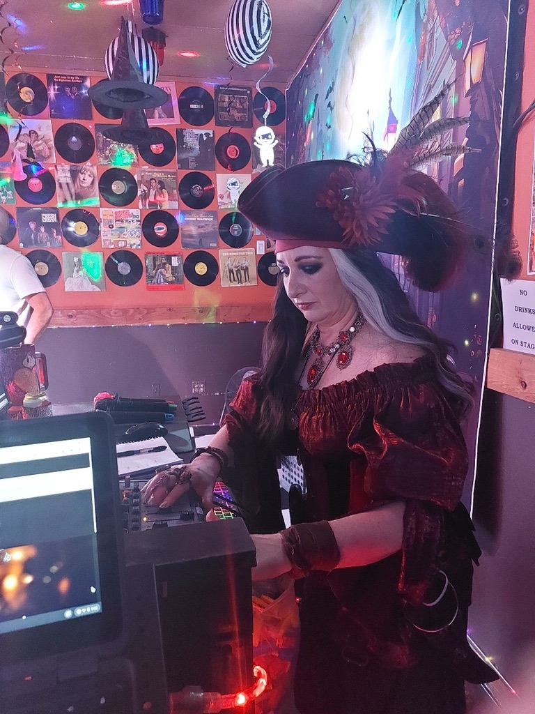 The author dressed up as her pirate personal, Captain Morgana, working the sound board as she runs her karaoke show at the Canary Roost.